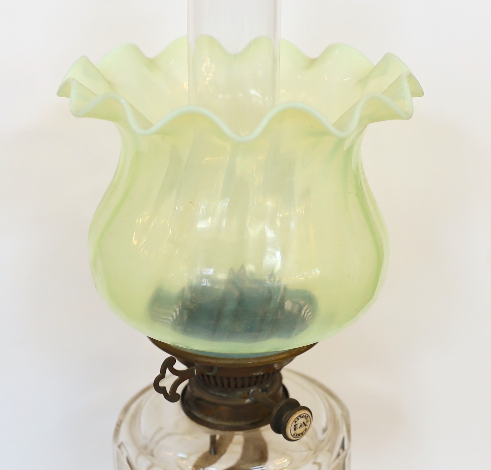 An Edwardian brass oil lamp with cut glass reservoir, Hinks No2 duplex mechanism, Vaseline shade and flue, height overall 67cm